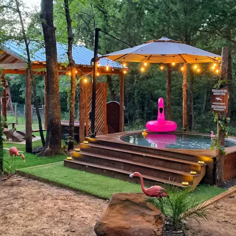 A luxurious hot tub surrounded by lush landscaping, perfect for relaxing after a day of resort activities at Oak Meadow Ranh RV in Valley View, TX.