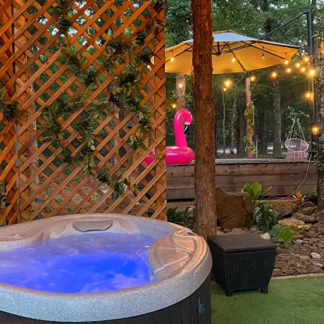 A luxurious hot tub surrounded by lush landscaping, perfect for relaxing after a day of resort activities at Oak Meadow Ranh RV in Valley View, TX.