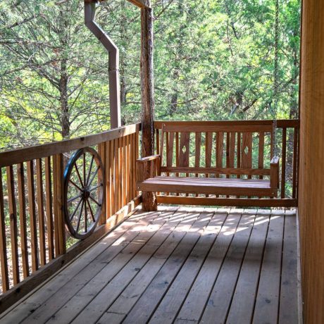 A luxury suite with large windows overlooking a giraffe barn, capturing the unique wildlife experience at Oak Meadow Ranh RV in Valley View, TX.