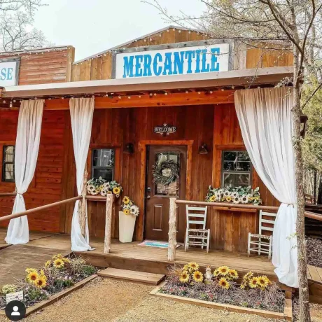 A luxury suite with large windows overlooking a giraffe barn, capturing the unique wildlife experience at Oak Meadow Ranh RV in Valley View, TX.