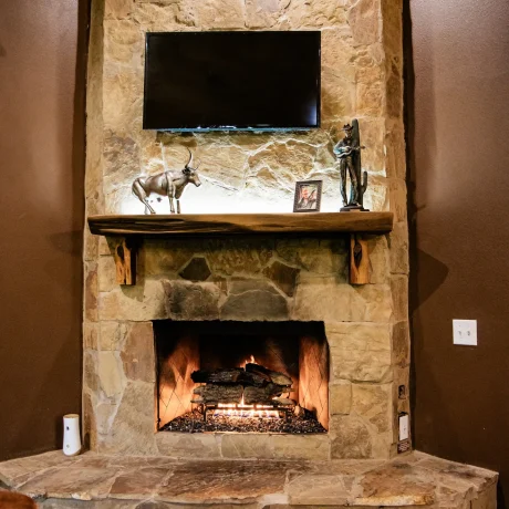 A luxury suite with large windows overlooking a giraffe barn, capturing the unique wildlife experience at Oak Meadow Ranh RV in Valley View, TX.